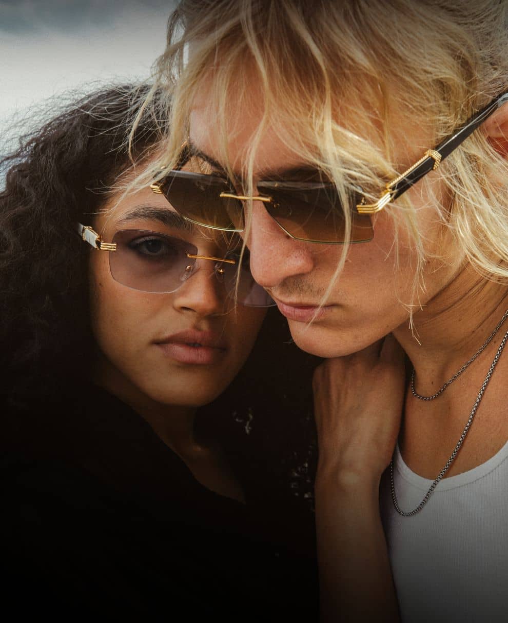 Woman and man wearing sunglasses on rooftop close up